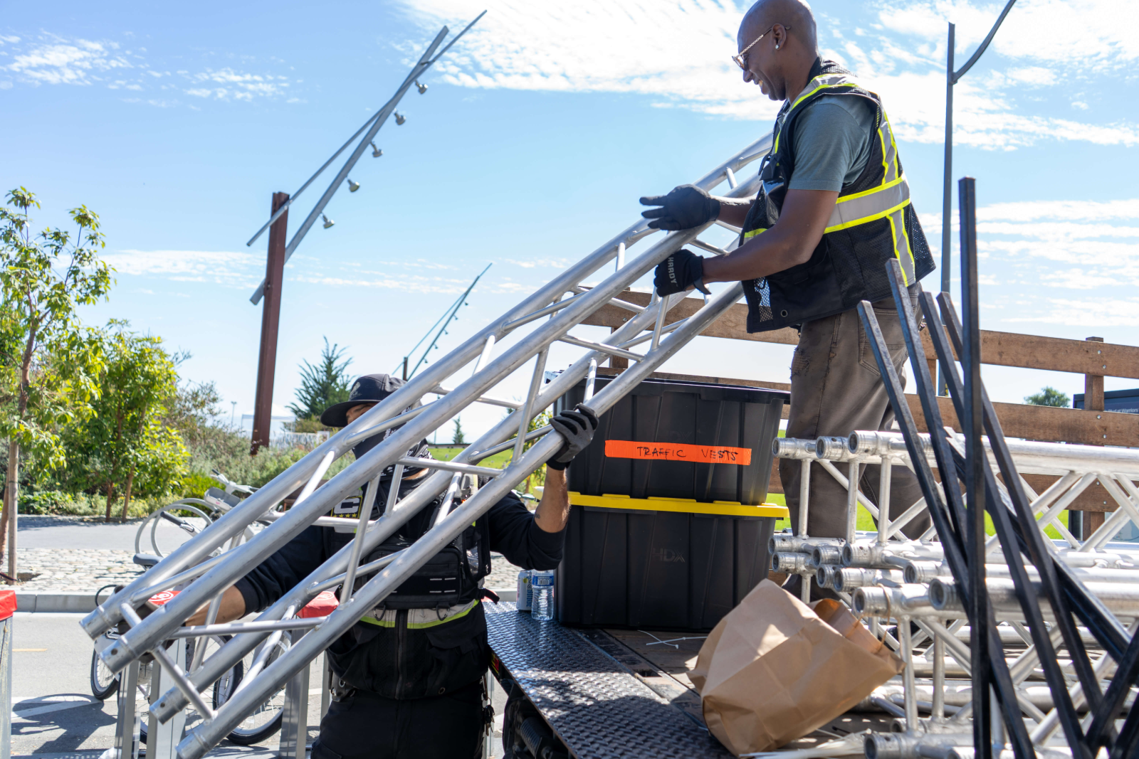 Silverback crew handing truss sections down from a flatbed at the Chase Corporate Challenge
