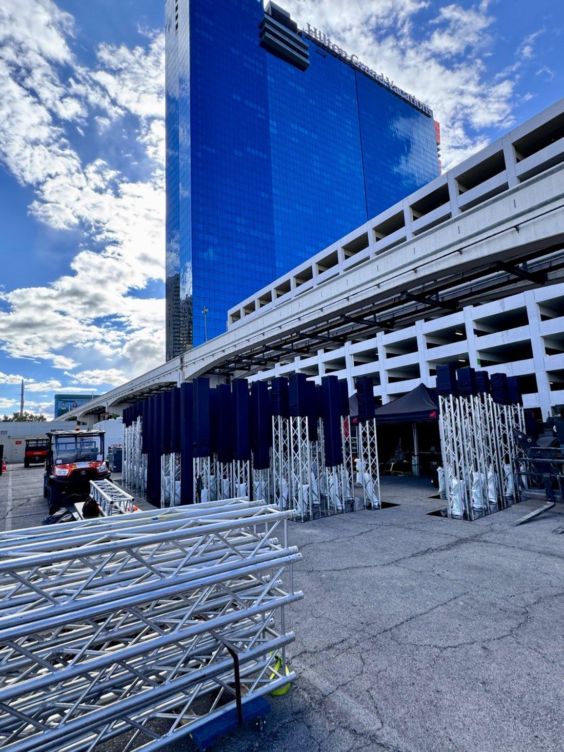 Truss structures staged during build-out beside the pedestrian bridge on Harmon Avenue