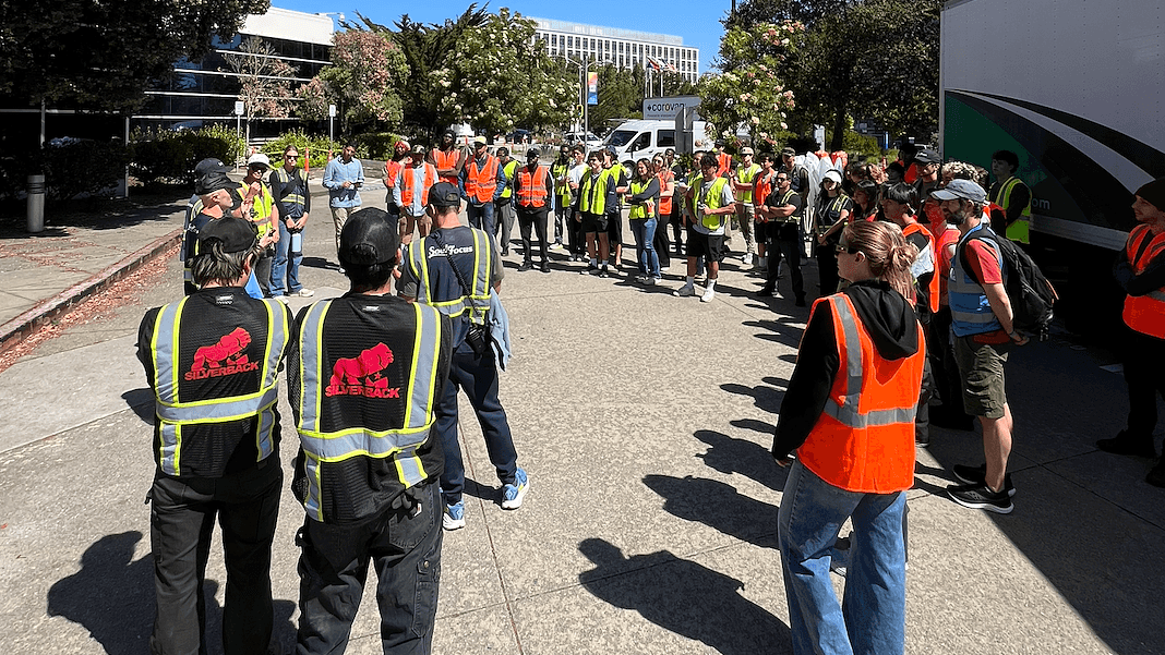 Silverback crew in high-visibility vests briefing volunteer marshals before the attempt