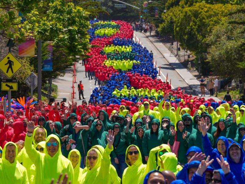 Genentech employees in colored hoodies forming the record-breaking human DNA helix on DNA Way