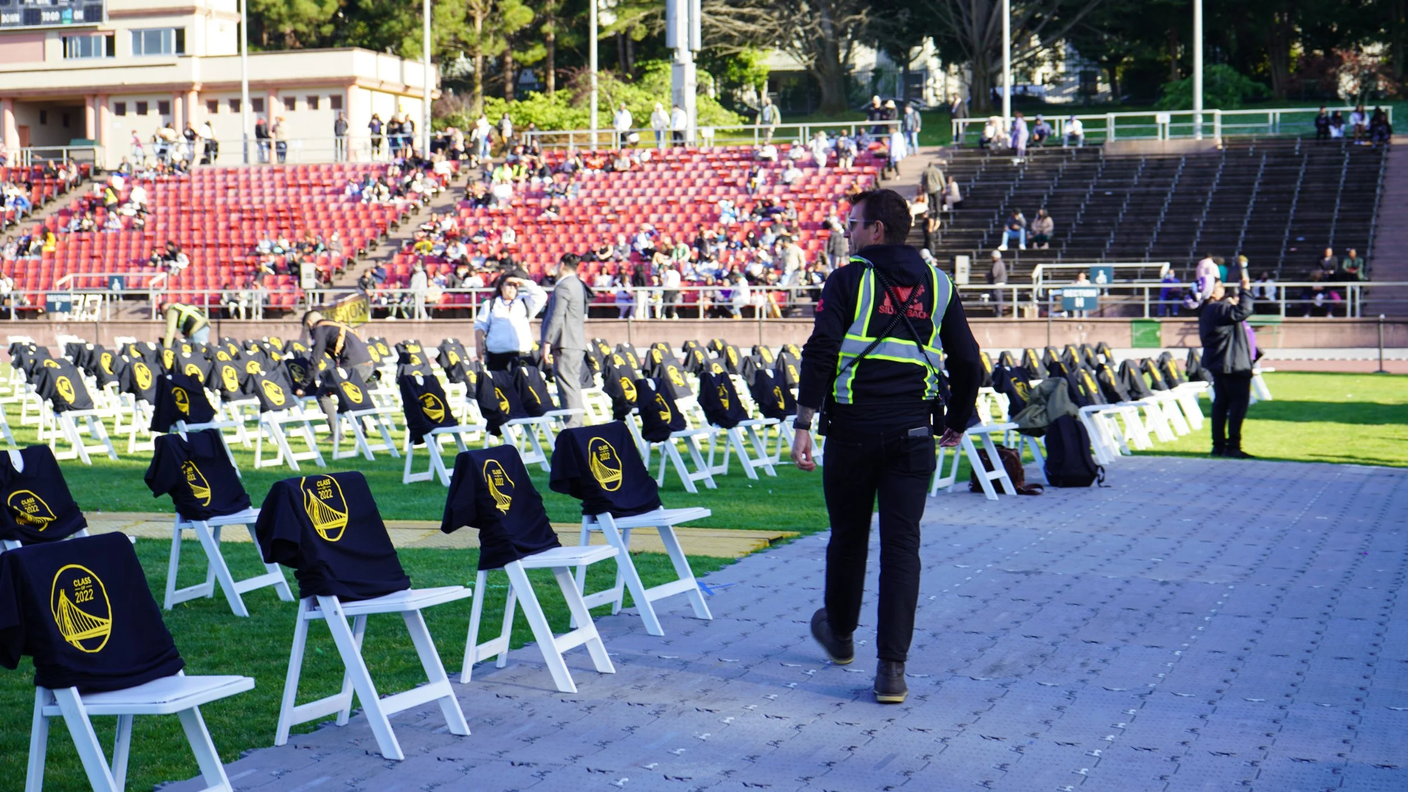Silverback crew lead walking the seating deck before a stadium ceremony